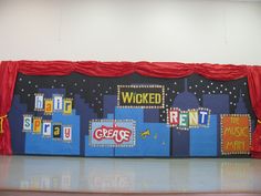 the stage is decorated with brightly colored signs and red drapes on it's sides