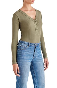 bodysuit a svelte option for all your plans.henleySleek all-in-one style and breathable stretch jersey makes this V-neck Long sleeves 94% cotton, 6% spandex Hand wash, dry flat Imported Model stats: 5'10" height, 32" bust, 25" waist, 36" hip. Model is wearing size Small. How To Wear A Bodysuit, Bodysuit With Jeans, Women's Henley, New York Street Style, Bodysuit Tops, Ladies Dress Design, Large Fashion, Jeans Dress, Unisex Clothing