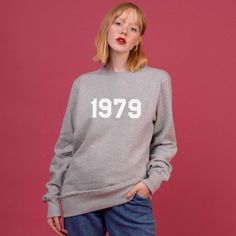 Make a style statement in this personalised year sweatshirt. A high-quality and stylish sweater to celebrate a special birthday. Our gorgeously soft sweatshirts are ethically made from 100% Organic Cotton and handprinted with any year of your choice. Create Your Own Sweatshirt: - Choose your Sweatshirt Colour - Choose Your Size - Add Your Year **Black, Navy, Pink and Grey sweatshirts with be printed with White Text. **White sweatshirts will be printed with Black Text. They can be personalised wi Trendy Crew Neck Sweatshirt For Birthday, Casual Winter Birthday Sweatshirt, Casual Long Sleeve Birthday Sweatshirt, Long Sleeve Fall Birthday Sweatshirt, Long Sleeve Winter Birthday Sweatshirt, Fall Birthday Sweatshirt With Graphic Print, Graphic Print Sweatshirt For Birthday In Fall, Winter Birthday Sweatshirt With Letter Print, Year Sweatshirt