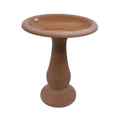 a brown ceramic bird bath sitting on top of a table