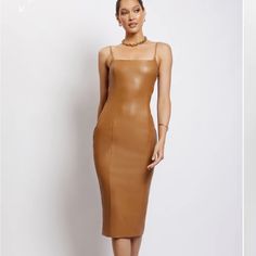 a woman wearing a tan leather dress