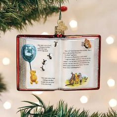 winnie the pooh book ornament hanging from a christmas tree