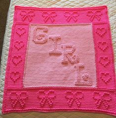 a pink crocheted blanket with an image of a cat on it