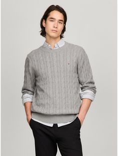 Tommy Hilfiger men's sweater. Made from soft cotton in a textured cable knit weave, this crewneck sweater is the perfect layer, complete with rib-knit cuffs, collar and hem with touches of subtle branding throughout.  Material: 100% Cotton. Classic Cotton Cable Knit Polo Sweater, Classic Cotton Cable Knit Sweater, Classic Textured Knit Sweater, Classic Cable Knit Polo Sweater, Tommy Hilfiger Sweater With Ribbed Cuffs For Fall, Tommy Hilfiger Fall Sweater With Ribbed Cuffs, Classic Cable Knit Crew Neck Sweater, Classic Crew Knit Sweater, Tommy Hilfiger Classic Crew Neck Sweater