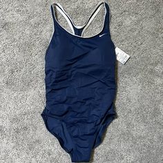 Nike Navy Swimsuit Padded Brand New With Tag Womens M Cheap Navy Swimwear For Sports, Professional Swimming Suits, Nike Nylon Swimwear For Summer, Sporty Blue Bodysuit For Pool, Nike Fitted Swimwear For Pool, Blue Sporty Bodysuit For Pool, Fitted Nike Swimwear For Pool, Casual Nike Swimwear For Pool, Nike Fitted Bodysuit For Beach