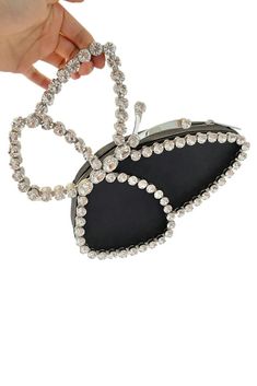 Elevate your style with our Black Butterfly Clutch, adorned with dazzling crystals. This exquisite accessory adds a touch of sophistication to any ensemble, perfect for glamorous evenings, cocktail parties, and formal affairs. Trendy Evening Jewelry With Rhinestones, Elegant Holiday Party Jewelry, Luxury Evening Jewelry With Bling, Elegant Evening Crystal Jewelry, Elegant Evening Holiday Jewelry, Chic Bling Jewelry For Night Out, Chic Crystal Jewelry For Evening, Luxury Bling Jewelry For Party, Silver Jewelry For Holiday Parties