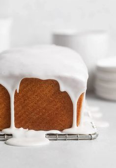 a bundt cake with white icing on a cooling rack