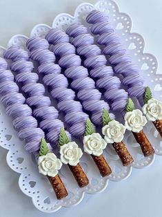 purple and white cake sticks with flowers on them