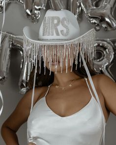 a woman wearing a white hat with icicles on it's brimmed