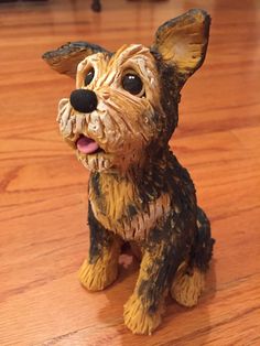 a small dog figurine sitting on top of a wooden floor