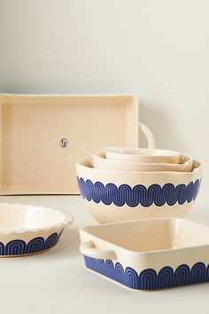 a set of blue and white dishes sitting on top of a table