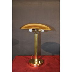 a gold colored lamp sitting on top of a red table