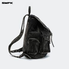 SMFK Compass Tarpan Denim Backpack Black (Large) - Design: A fresh design for 2024 by SMFK, this denim backpack is a new addition to their collection. The design takes inspiration from common detailing found in denim jackets and shorts, allowing for adjustable capacity. Features a three-dimensional external pocket, echoing the workwear pocket style from SMFK's workwear collection. Size F - Length: 35cm, Width: 17.5cm, Height: 41cm Composition: 72.8% Cotton, 23.6% Polyester, 3.6% Viscose Denim Backpack, Suit Pant, Bags Shop, Fresh Design, Denim Jackets, Black Backpack, Black Denim, Compass, Three Dimensional