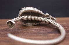 Large Silver ear ornaments. The hoops are made of pearled wire and the bezel is decorated with a large blue Turquoise. Excellent workmanship with a great patina for its age. This is a rare Museum piece. This particular design is worn in pairs by women and single by men from Kham in East Tibet. These pieces might have been handed down to generations. *wear and tear as per age, intact. Combined Weight: 42 grams Ring Size: 48mm Origin: Early 19th c Tibet Antique Finish Chandbali Jewelry Gift, Antique Finish Chandbali Jewelry As A Gift, Chandbali Jewelry With Antique Finish For Gift, Chandbali Jewelry With Antique Finish As Gift, Traditional Adjustable Hoop Jewelry, Antique Hand Forged Jewelry For Ceremonies, Traditional Hoop Jewelry As A Gift, Handmade Vintage Spiral Jewelry, Traditional Engraved Round Hoop Earrings