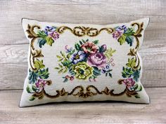 an embroidered pillow with flowers on it