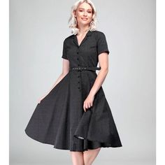 The prim and proper 1950s housewife look, but with a contemporary edge. This classic shirt dress has a flattering open neck style and notched collar detail, and wooden buttons fastening the center front. A cute slide belt backed with PU cinches in your waist, and the sleeves have slim cuffs. The fabulously full swing skirt accommodates a petticoat, should you wish to wear one, but looks equally beautiful without one. And best of all, the skirt contains side seam pockets! Retro Pinup