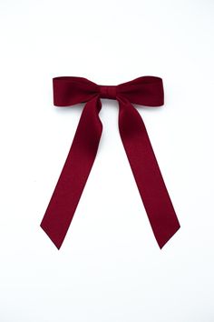 The It Girl Bow! Grace and Grandeur Bow Company’s lovely Florence bow in stunning matte satin ribbon is an accessory staple year round. This bow features beautiful medium length ribbon tails and suits many hair styles.Dimensions The Florence Bow measures approximately 5.5" wide and tails are approximated 7.5" long from top of bow to longest tip. This bow is secured on a 3" barrette.* Luxe Matte Satin Ribbon* Classic Bow * French Barrette* Size | 5”W x 6”L* Grandmillennial StyleMade in the USA*Pl Red Hair Ribbon, Maroon Hair, The It Girl, Bow Organizer, Christmas Day Outfit, Satin Ribbon Bow, Burgundy Hair, Hair Ribbon, Bow Accessories