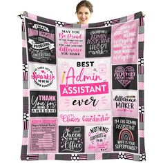 a woman holding up a pink and black blanket with the words best assistant ever on it