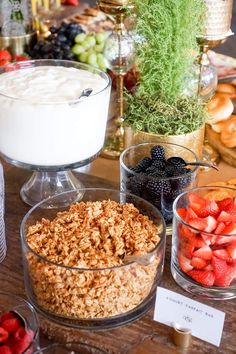 a table topped with bowls of cereal and fruit