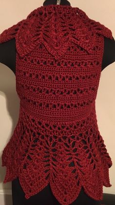 a red crocheted top on a mannequin