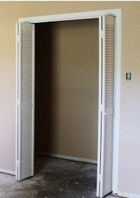 an empty room with two doors open in it