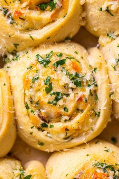 several rolls with cheese and herbs on top are shown in close up view from above