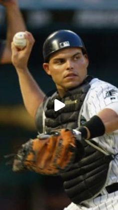 a baseball player throwing a ball in the air with his mitt up to his chest