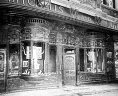 an old black and white photo of a store front