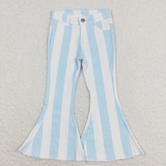 a pair of blue and white striped pants with bell bottoms on the bottom, sitting on carpet