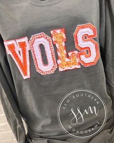 a person wearing a sweatshirt with the word volls on it