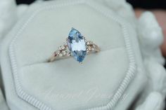 This ring features a gorgeous sparkle sky blue sapphire, sparkling and eyeclean. It is set in a cluster setting with VS white diamonds on either side. You can order this ring in 14K yellow, rose or white gold.Main stone: Natural blue Ceylon sapphire eye clean, unheated. Dimension: Length : 12.92 mm Width. : 6.39 mm, Weight. : 2.64 CaratsShape:MarquiseSide stones: VS White GH color diamonds round 1.2mm (8) ,1.3 (6).Material: 14K yellow, rose or white goldAvailable Sizes: USA 3 - USA 11 (larger & Marquise Blue Topaz Promise Ring, Blue Marquise Topaz Ring For Anniversary, Blue Marquise Topaz Promise Ring, Marquise Blue Topaz Ring For Wedding, Blue Topaz Marquise Wedding Ring, Elegant Blue Topaz Marquise Ring, Elegant Blue Marquise Cut Topaz Ring, Blue Marquise Diamond Ring For Anniversary, Blue Marquise Cut Topaz Ring For Anniversary