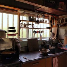 the kitchen is cluttered with pots and pans