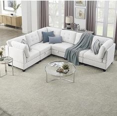 a living room with white furniture and gray carpet