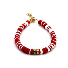 a red and white beaded bracelet with gold accents on a white background - product images