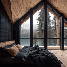 a large bed sitting inside of a bedroom on top of a wooden floor next to a window