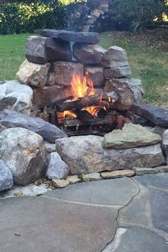 an outdoor fire pit with rocks surrounding it