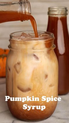 pumpkin spice syrup being poured into a mason jar with the words, pumpkin spice syrup