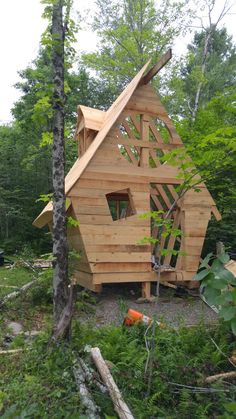 a house made out of wood in the woods