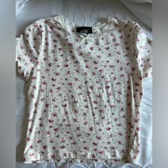 -Just Polly Pink Floral Coquette Top -Perfect Condition, Never Worn -Size M But Can Fit A Small Too -Lace Trimming And Bow Detail On Neckline Fitted White T-shirt With Floral Print, Spring Cotton T-shirt With Lace Trim, Fitted Lace Trim T-shirt For Summer, Casual Lace Trim T-shirt For Spring, Trendy Cream Floral Print Tops, Casual Cream Floral Print Top, Casual Cream Tops With Floral Print, Coquette Top, Pink Floral Top