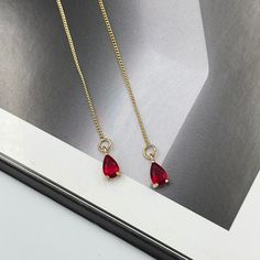 Dainty Ruby Red Thread Earrings, Red Teardrop Earrings, Statement Ruby Red Drop Earrings, Long Red Dangle Earrings, Red Thread Earrings. These are simple and beautiful tiny red teardrop crystal earrings. Red crystals are framed in bright gold and dangling from long thread. Measurements: The total length from the top of the hook to bottom - 3.54 inches (90 mm) approximately. Crystals: 5 mm The earrings would be a PERFECT GIFT for you and your family and friends! Click here to see more Modern Ever Minimalist Red Jewelry For Party, Minimalist Red Party Jewelry, Red Drop Crystal Earrings As Gift, Dainty Red Earrings For Everyday, Minimalist Red Teardrop Jewelry, Red Drop Earrings For Pierced Ears, Gold And Red Earrings Dangle, Red Minimalist Dangle Earrings, Red Ruby Drop Earrings