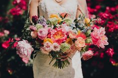 a woman holding a bouquet of flowers in her hands