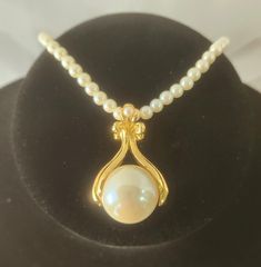 A large 3/4" faux creamy white pearl surrounded by gold tone metal work hangs from an opera length  (32" unclasped or 16" clasped) strand of matching faux pearls.  This is such an elegant necklace and is sure to make a statement when worn.  It has a nice working spring ring clasp and a NR AVON marked tag.   It is truly lovely!   Marking: AVON Era:  Vintage 1990s Condition:  Preowned I do not pack in gift boxes to prevent excess waste. However, if you would like a gift box, message me directly an Avon Mark, Professional Jewelry, Vintage Avon, Elegant Necklaces, Gold Tone Metal, Spring Rings, Pearl White, Faux Pearl, Metal Working