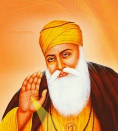 an old man with white beard and yellow turban holding his hand up to the side