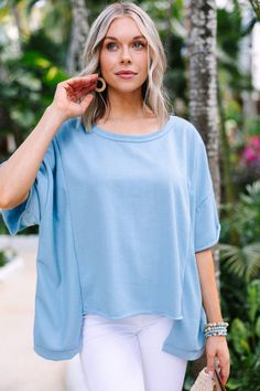 Feel relaxed and comfortable in this easy-to-wear denim blue oversized top. With a casual style and a focus on comfort, you'll be sure to enjoy wearing this top! Plus, you'll find plenty of ways to wear it since it can style with jeans or shorts, sandals or sneakers! This top features short sleeves, a round neckline, high low hemline, and an oversized fit.  Material has a generous amount of stretch.Cam is wearing the small. Style With Jeans, Capsule Wardrobe Basics, Stylish Tops For Women, Floral Cocktail Dress, Black Tie Dress, Long Sleeve Outerwear, Capsule Outfits, Two Piece Swimwear, Friend Outfits