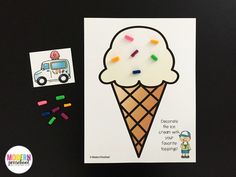 an ice cream cone with colored crayons next to it on a black surface