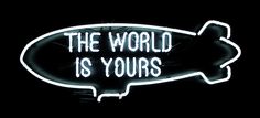 a neon sign that says the world is yours in white letters on a black background