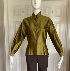 "Romeo Gigli in the early 1990s designed for Callaghan using the same elegant fabrics that he used in his own line.  This blouse is 109% silk shantung.  From my private Romeo Gigli collection. Unworn. Pristine.  Size I44, USA8 Mandarine collar.  Long sleeves.  Made in Italy Excellent workmanship. Made by Zamasport, the same factory in Italy that made his own line.  Finished interior seams. No raw edges.  Front button closure.  Side seam slits. Asian feel to this blouse.  Double pleats at the cuf Fall Blouse With Stand Collar, Classic Stand Collar Blouse For Fall, Fitted Long Sleeve Blouse With Covered Buttons, Fitted Blouse With Covered Buttons For Fall, Fall Fitted Blouse With Covered Buttons, Fitted Fall Blouse With Covered Buttons, Designer Fitted Long Sleeve Blouse, Formal Stand Collar Top For Fall, Fitted Silk Blouse With Long Sleeves