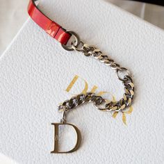 Description designed by John Galliano Red patent leather and chain belt "Dior" name plate Swarovski encrusted clasp drop down chain w/ monogram "D" adjustable comes w/ box, dustbags, and authenticity certificate Condition: great patent has a few minor color transfer spots Measurements tag size: 90 length: 33-38" Designer Formal Jewelry With Chain Strap, Luxury Jewelry Gift With Metal Logo, Luxury Jewelry With Metal Logo For Gift, Designer Formal Jewelry With Metal Logo, Luxury Leather Jewelry With Logo Charm, Dior Waist Chain, John Galliano Dior Bag, John Galliano Saddle Bag, Vintage Dior Bracelet