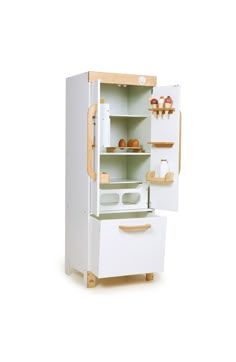 a white refrigerator freezer sitting next to a wooden shelf filled with bread and pastries