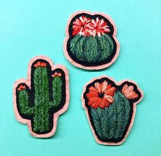 three embroidered cactus patches sitting on top of a blue table next to an instagramt